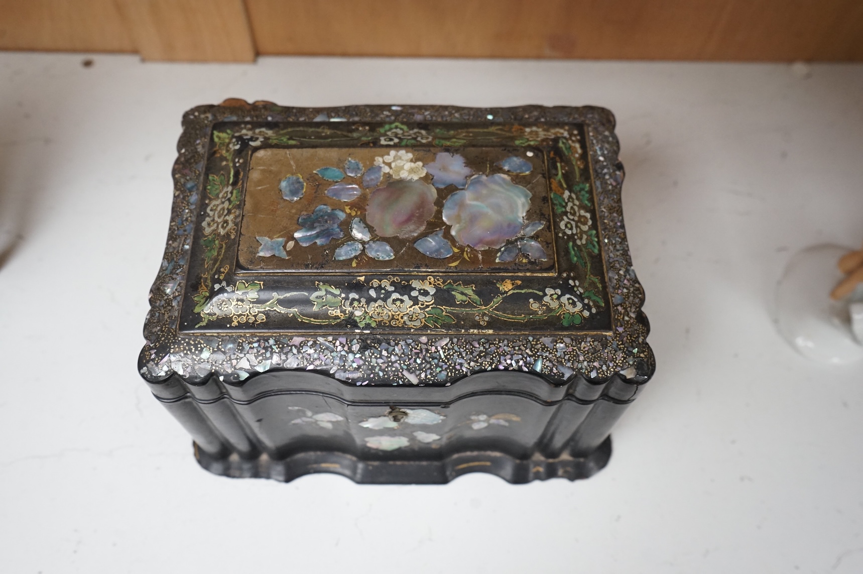 A Victorian Jennens & Bettridge papier mache tea caddy with abalone inlay, 21cm wide